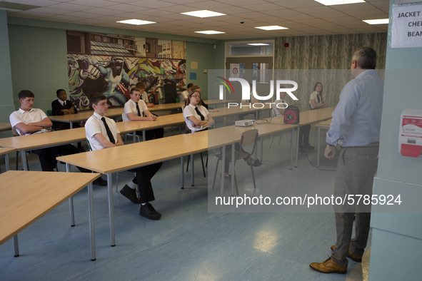   Year 10 pupils watch on as the head teacher gives a presentation . Ortu Gable Hall School in Corringham, Essex return after a long break d...
