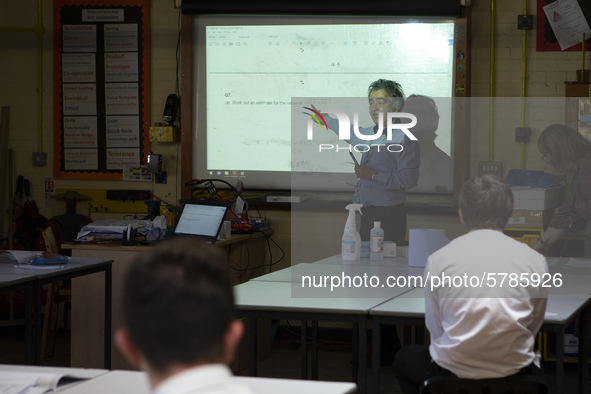   Year 10 pupils watch on as the teacher points to the whiteboard . Ortu Gable Hall School in Corringham, Essex return after a long break du...