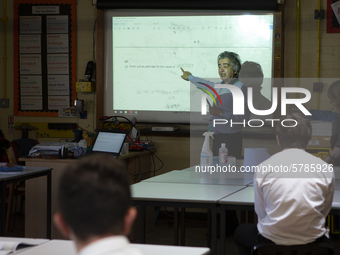   Year 10 pupils watch on as the teacher points to the whiteboard . Ortu Gable Hall School in Corringham, Essex return after a long break du...
