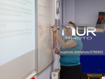  A teacher at the front of a class of Year 10 pupils. Ortu Gable Hall School in Corringham, Essex return after a long break due to the COVID...