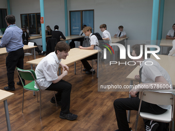   A general view of Year 10 pupils taking their break in the canteen. Ortu Gable Hall School in Corringham, Essex return after a long break...