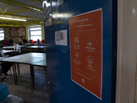  A COVID-19 poster on the door with the year 10 class inside. Ortu Gable Hall School in Corringham, Essex return after a long break due to...