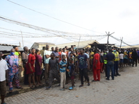 People gather at the scene of the building collapse at Gafari Balogun street, Ogudu area of Lagos on June 17, 2020. (