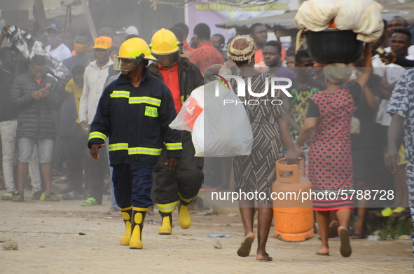  A woman rescue some remains of his belongings after a building collapse at Gafari Balogun street, Ogudu area of Lagos on June 17, 2020 