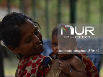 AN indian lady,lives in roadside temporary houses,holds her newly born kid on ocassion of mother's day in Allahabad on may 10,2015. (