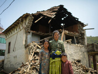 Muia Thapa is standing with her grand children in front of her destroyed buildings. Sankhu, Nepal. May 3, 2015 (