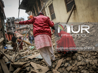 Mother and daughter are struggling to go through the roads of rubbles. Sankhu, Nepal. May 9, 2015 (