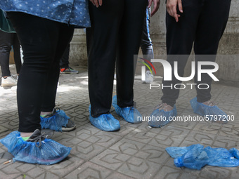 the students wear foot gloves during the first day of the high school exams in Giza Governorate, Egypt, on June 21, 2020.  (
