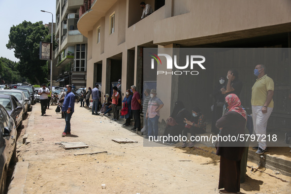 The parents waiting the students exit outside the examination committee during the first day of high school exams in Giza Governorate, Egypt...