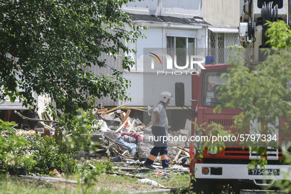 Ukrainian rescue workers clean debris after a suspected gas explosion  in an apartment building in Kyiv, Ukraine, 21 June 2020.  