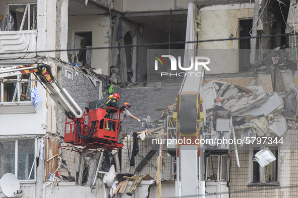Ukrainian rescue workers clean debris after a suspected gas explosion  in an apartment building in Kyiv, Ukraine, 21 June 2020.  