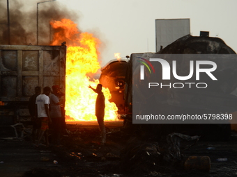 A man stand in between a burning fire during a tanker explosion involving four articulated vehicles on the Kara bridge section of Lagos-Ibad...