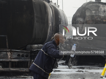 A fire fighter wash his face with a bottle water after putting from gas explosion involving four articulated vehicles on the Kara bridge sec...