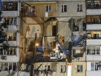 Ukrainian rescue workers clean debris after a gas explosion in nine-stored apartment building in Kyiv, Ukraine, 21 June 2020.  (