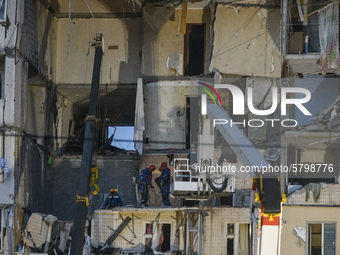 Ukrainian rescue workers clean debris after a gas explosion in nine-stored apartment building in Kyiv, Ukraine, 21 June 2020.  (