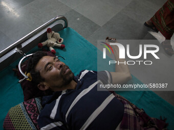 Nanda, 43 is badly injured in his shoulder and spinal cord due to collapse of his house. Trauma Hospital, Kathmandu, Nepal. May 6, 2015. (