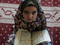 A girl attends a Koran memorization class as Palestinians ease the coronavirus disease (COVID-19) restrictions, in a mosque in Gaza City Jun...