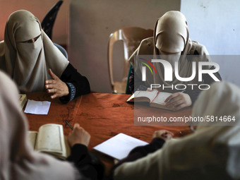 women keeping a safe distance from each other,attend a Koran memorization class as Palestinians ease the coronavirus disease (COVID-19) rest...