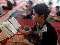  Boys keeping a safe distance from each other,attend a Koran memorization class as Palestinians ease the coronavirus disease (COVID-19) rest...
