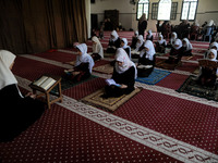 Girls keeping a safe distance from each other,attend a Koran memorization class as Palestinians ease the coronavirus disease (COVID-19) rest...