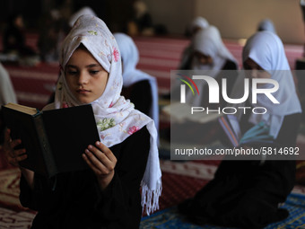 Girls keeping a safe distance from each other,attend a Koran memorization class as Palestinians ease the coronavirus disease (COVID-19) rest...