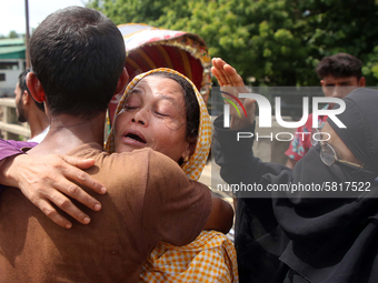 Relatives of a victim cry after recovered bodies of victims following the Launch capsized in Buriganga River in Dhaka, Bangladesh on June 30...