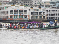Commuters travel on a crowded ferry boat across the Buriganga River the day after a ferry capsized, in Dhaka on June 30, 2020. At least 32 p...