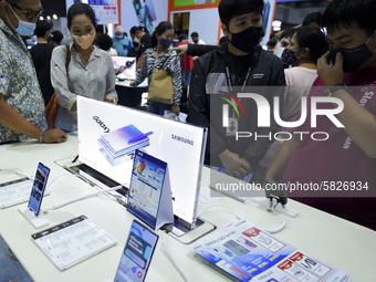 Visitors wear protective facemasks inspect Samsung at the Thailand Mobile Expo 2020 in Bangkok, Thailand, 04 July 2020. (