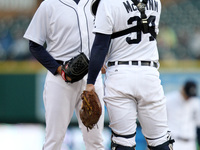 Detroit Tigers catcher James MacCann talk to starter Kyle Lobster during the third inning of a baseball game against the Detroit Minnesota T...