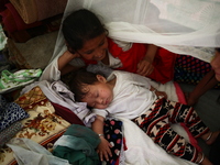 A young girl is cuddling her sister in a make shift camp near Kathmandu May 14, 2015  (