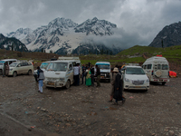 ZOJILA, INDIAN ADMINISTERED KASHMIR, INDIA - MAY 13: Indian tourists board and alight vehicles in sonmarg on the snow-cleared Srinagar-Leh h...