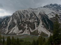 ZOJILA, INDIAN ADMINISTERED KASHMIR, INDIA - MAY 13: River Sindh flows next to the snow-cleared Srinagar-Leh highway on a treacherous pass...