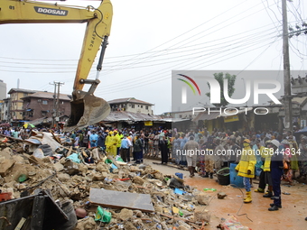 Hundreds of people gather at the scene of a three-story building collapse barricade by the police, where three persons have been confirmed d...