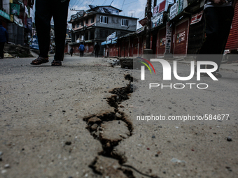 A cracked street after the 7.4 deadly earthquake at Charikot, Dolkha, Nepal, 13 May 2015. This is one of busiest street of Charikot which is...