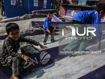 Children are playing over thge broken roof of a NCELL shop at Charikot, Dolkha, 13 May 2015. (