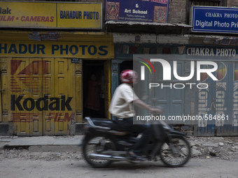 KHATMANDU, NEPAL-- May 14, 2015- A motorcyclist passes through a narrow street in the old city of Kathmandu. The city is slowly getting back...