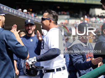 Detroit Tigers' Miguel Cabrera is congratulated by teammates in the dugout after his two-run home run in the seventh inning of a baseball ga...