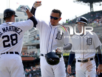 Detroit Tigers' Miguel Cabrera is congratulated by J. D. Martines after his two-run home run in the seventh inning  of a baseball game again...