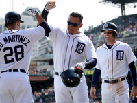 Detroit Tigers' Miguel Cabrera is congratulated by J. D. Martines after his two-run home run in the seventh inning  of a baseball game again...