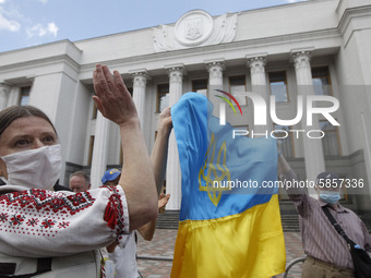 Ukrainians take part at a rally in support Ukrainian language and against a bill which offers to extend the use of the Russian language in U...