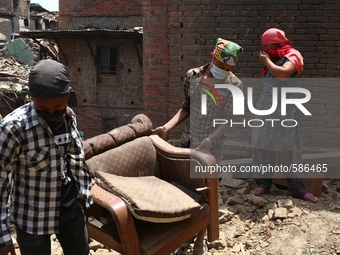 Two men are carry their furniture from the rubble Bhaktapur, May 5 2015 (