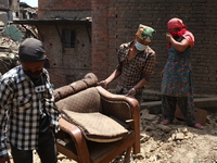 Two men are carry their furniture from the rubble Bhaktapur, May 5 2015 (