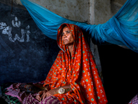 Flood affected Anjuman Bagum(50) takes shelter in a school building along with her family and livestock in Jamalpur, Bangladesh, on July 20,...