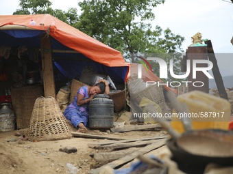 SINDHUPALCHOK, NEPAL-- May 15, 2015-- A woman naps on top of the few remaining possessions salvaged from the earthquakes in the village of H...