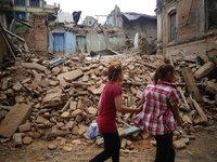May 16, 2015,  Kathmandu, Nepal -- People walk pass the collapse house in Sankhu, Kathmandu.                                (