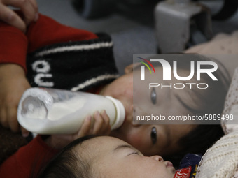March 15, 2011-Fukushima, Japan-Japanese infants wait for escape airplane at airport in Fukushima on March 15, 2011, Japan. On 11 March 2011...