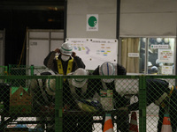 March 16, 2011-Sendai, Japan-Japanese construction workers check for crack site recovery at front of railway station in Sendai on March 16,...