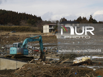 March 17, 2011-Sanriku Minami, Japan-Forkcrane clean up with find burial person on Tsunami hit the destroyed city in Sanriku Minami, north e...