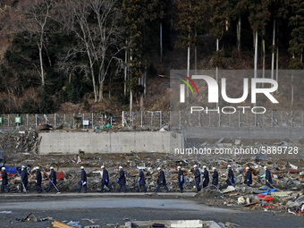 March 18, 2011-Rikuzen Takata, Japan-Rescue Team stop searching with going to their camp at Debris and Mud covered on Tsunami hit Destroyed...