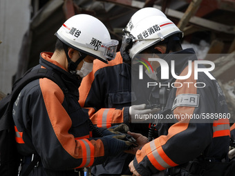 March 20, 2011-Rikuzen Takata, Japan-Rescue Team searching operation on debris and mud covered at Tsunami hit Destroyed city in Rikuzentakat...